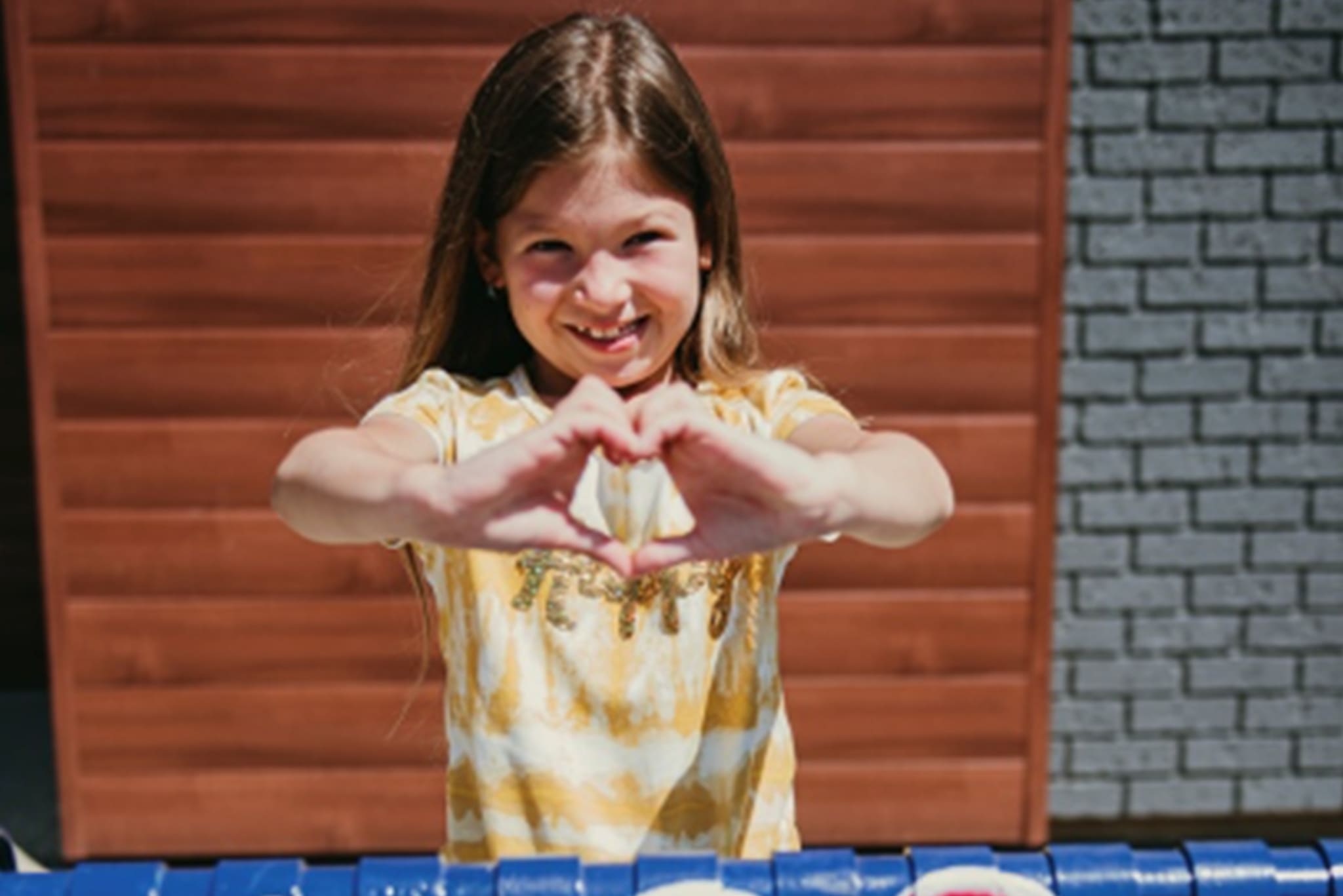 Girl showing with heart sign Girl showing with heart sign